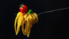 fork with pasta lettuce and tomato. 