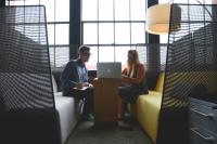 woman and man looking at computer