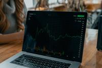 Image: graphs on laptop. Title: Shareholder Activism
